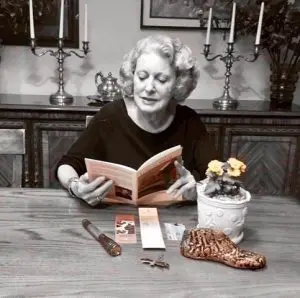 The plant embodies the subject’s nurturing nature. The flashlight symbolizes that her deceased husband “lit the way” for her. Notice how the candlesticks are carefully placed to frame the portrait.