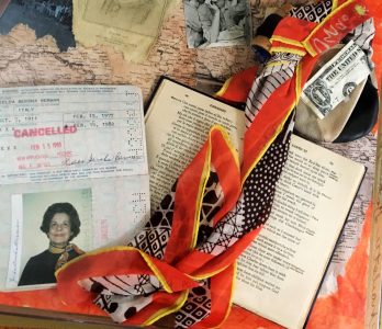 This photograph includes the orange scarf the subject wore in the first passport photo she received as a US citizen; her first dollar bill earned in America; a map of her early life in Eastern Europe; and a copy of Dante’s Inferno, the book her American teacher told her she would one day read though she spoke no English.